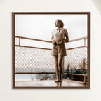 Sepia photograph with colour touches of a 1950s woman on a balcony above Playa Cojimar, framed in oak. Close view.