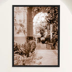 Sepia photograph of a shaded Spanish Colonial monastery patio filled with tropical plants, framed in oak. Close view.