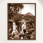Sepia photograph from 1948 Trinidad, Cuba of a woman beside a stone garden statue, framed in oak. Close view.
