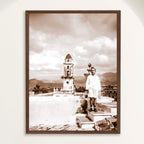 Sepia photograph of Trinidad's bell tower and the Valle de los Ingenios beyond, taken in 1948, framed and shown on a wall. Close view.