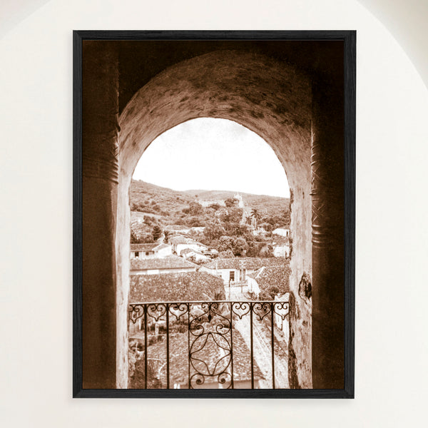 Framed vintage sepia 1948 photograph of Trinidad Cuba vista through the bell tower arch of San Francisco monastery. Close view.