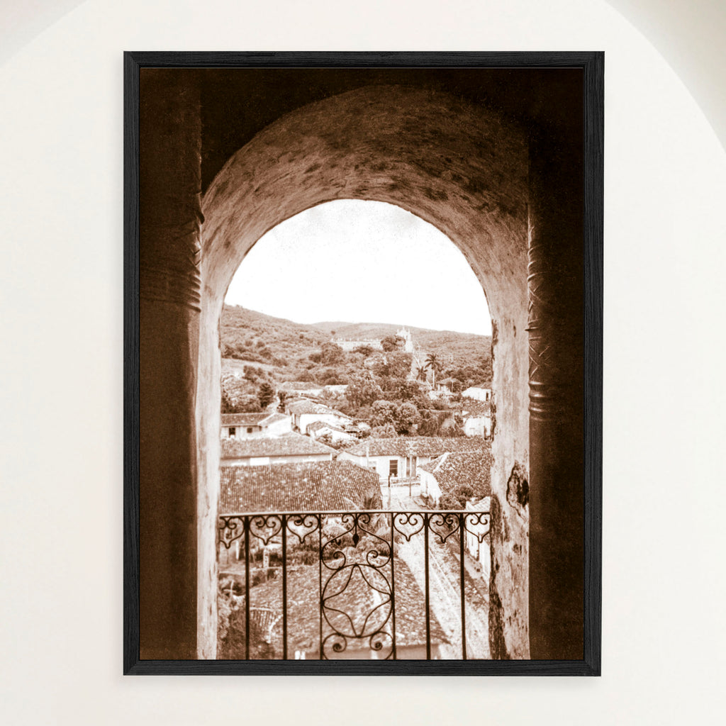 Framed vintage sepia 1948 photograph of Trinidad Cuba vista through the bell tower arch of San Francisco monastery. Close view.