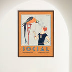A framed art print featuring a 1920s Art Deco illustration with a parrot and a woman displayed on a white wall in an arched alcove. Gallery view.