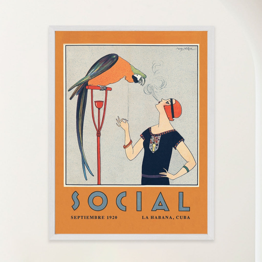 A framed vintage-style Art Deco Cuba illustration hangs on a dark green paneled wall in a modern living room. Art shows a 1920s flapper woman, with black dress and red hair, smoking a cigarette while a colorful parrot watches the rising smoke.From Atlantic & Havana - atlanticandhavana.com