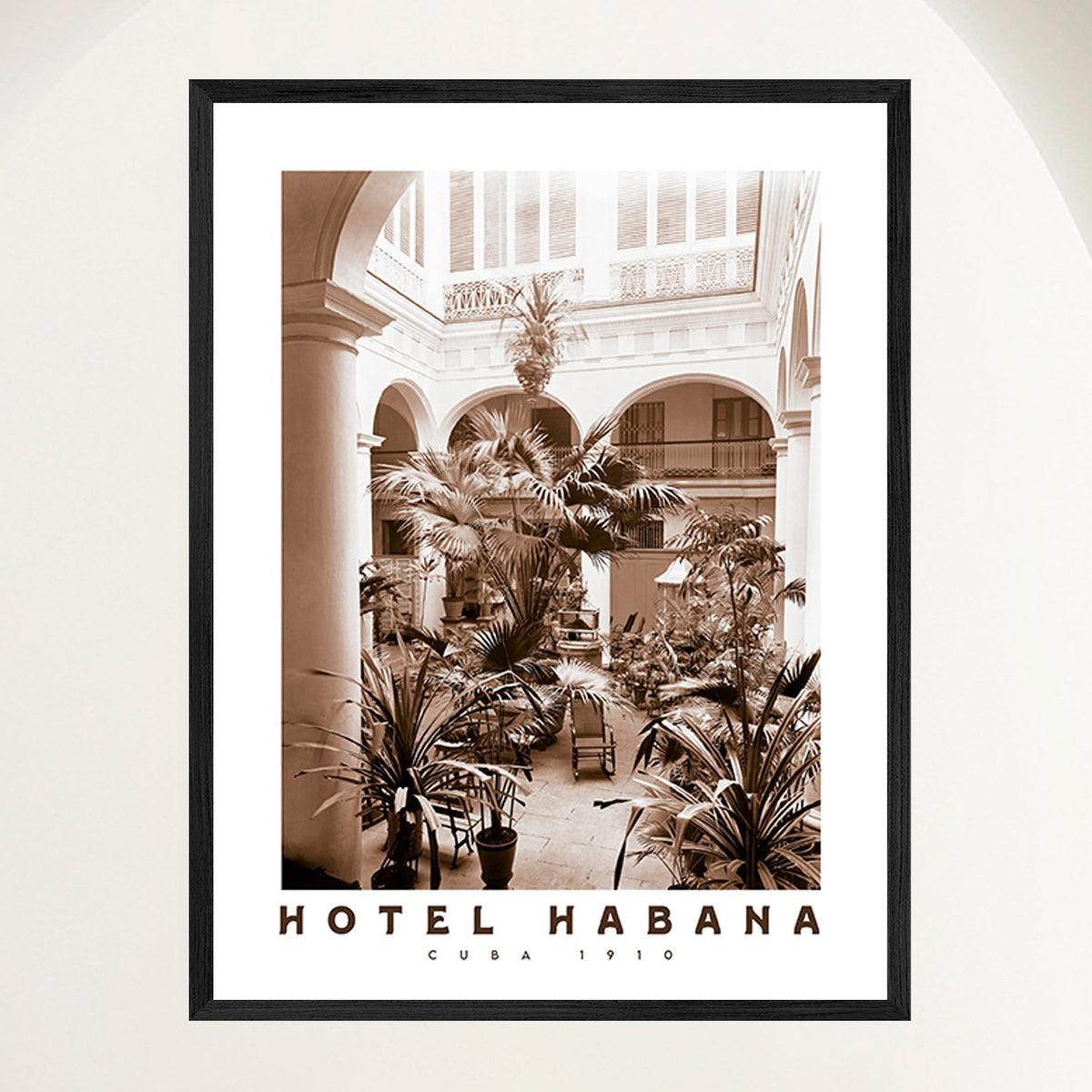 Vintage travel poster of a Spanish Colonial hotel courtyard garden in early 1900s Havana, framed in oak. Close view.