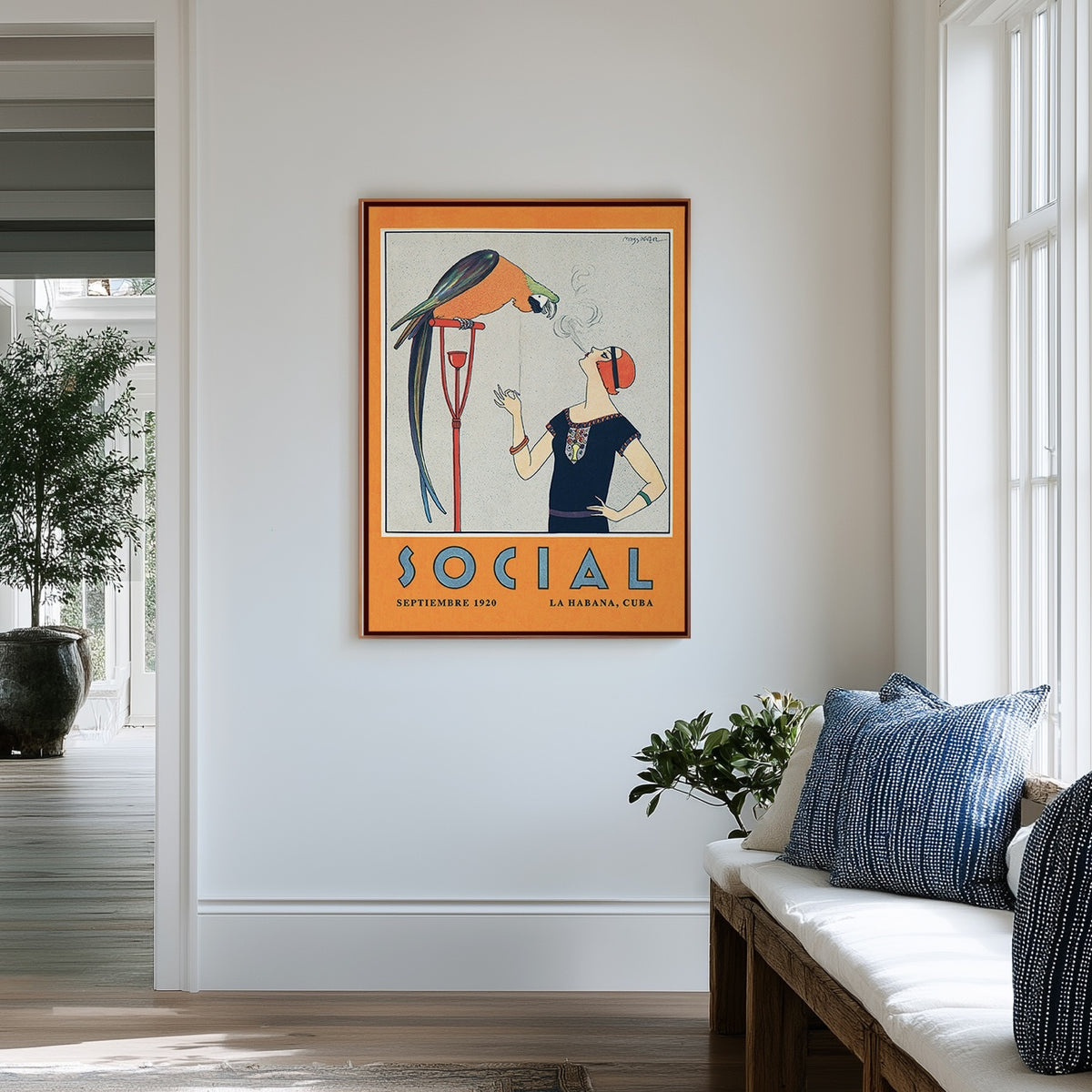 A framed vintage-style Art Deco Cuba illustration hangs on a white wall in a bright window interior. The artwork shows a bird perched on a cigarette holder as it watches  a 1920s flapper woman smoking. Below is  the word "SOCIAL" in blue letters. From Atlantic & Havana - atlanticandhavana.com
