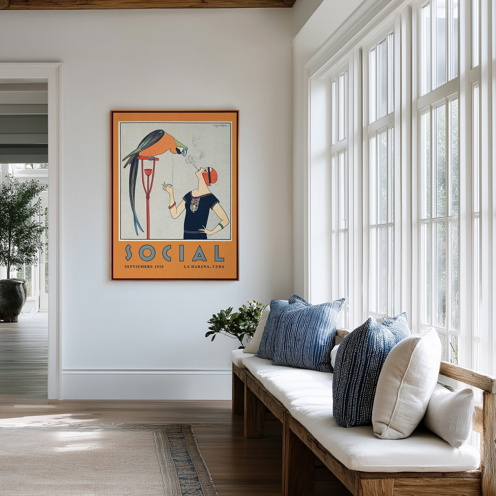 A framed vintage art deco illustration with flapper woman and large parrot hangs on a white wall in a bright hallway with a wooden bench, white cushions, and large windows.